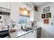 Well-lit kitchen featuring stainless steel appliances, granite countertops, and a cozy window view at 1100 E Caroline St # 204, Tavares, FL 32778