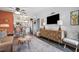 Cozy living room featuring a modern media center and comfortable seating arrangement at 1100 E Caroline St # 204, Tavares, FL 32778