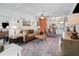 Bright living room flows to kitchen, showcasing stylish furnishings and open layout at 1100 E Caroline St # 204, Tavares, FL 32778