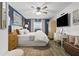 Stylish main bedroom featuring refined decor, natural light, and warm wood-look floors, perfect for relaxation and comfort at 1100 E Caroline St # 204, Tavares, FL 32778