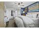 Well-lit main bedroom with wood-look floors, a plush bed, and an ensuite bathroom entrance for added convenience at 1100 E Caroline St # 204, Tavares, FL 32778