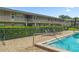 A view of the pool highlighting seating and landscaping at 1100 E Caroline St # 204, Tavares, FL 32778
