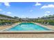 Resort-style pool area surrounded by lush landscaping and seating with several lounge chairs at 1100 E Caroline St # 204, Tavares, FL 32778