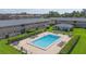 Relaxing community pool area with lounge chairs surrounded by manicured greenery at 1100 E Caroline St # 204, Tavares, FL 32778