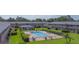 Community pool area surrounded by lush greenery, landscaping, and lounge chairs at 1100 E Caroline St # 204, Tavares, FL 32778