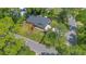 Aerial view of a property featuring a well-maintained lawn, mature trees, and neighborhood surroundings at 1200 Ridge Rd, Longwood, FL 32750