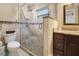 Elegant bathroom with a glass-enclosed shower, decorative tile accents, and a dark wood vanity at 1200 Ridge Rd, Longwood, FL 32750