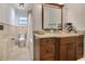 Well-maintained bathroom with a large mirror over a vanity with stone counters and a shower-tub combo at 1200 Ridge Rd, Longwood, FL 32750