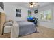 Bright bedroom featuring a blue and white checkered bedspread, a ceiling fan, and a built-in desk area at 1200 Ridge Rd, Longwood, FL 32750