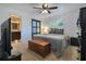 Cozy bedroom featuring neutral tones, a ceiling fan, a sliding closet door, and a view of the bathroom at 1200 Ridge Rd, Longwood, FL 32750