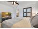 Well-lit bedroom with soft, neutral colors, a sliding closet door, and a large-screen television on a console at 1200 Ridge Rd, Longwood, FL 32750