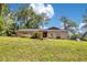 Inviting single-story house with beautiful yard and blue skies, perfect for a growing Gathering at 1200 Ridge Rd, Longwood, FL 32750