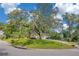 Corner lot showcasing a well-kept lawn, established trees, and a glimpse of the home's charming exterior at 1200 Ridge Rd, Longwood, FL 32750