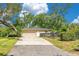 Charming home with a two-car garage, a well-manicured lawn, and mature trees at 1200 Ridge Rd, Longwood, FL 32750