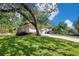 Single-story home with well-maintained lawn, long driveway, and a large shade tree at 1200 Ridge Rd, Longwood, FL 32750