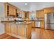 Spacious kitchen with light wood cabinets, granite counters, stainless appliances, and hardwood flooring at 1200 Ridge Rd, Longwood, FL 32750