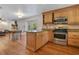 Stylish kitchen showcasing a center island with seating, stainless steel appliances, and hardwood flooring at 1200 Ridge Rd, Longwood, FL 32750