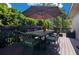 Outdoor dining space featuring a table with umbrella and cushioned chairs on a wooden deck at 1200 Ridge Rd, Longwood, FL 32750