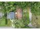 Aerial view of a single Gathering home surrounded by lush trees and greenery with a long driveway at 121 W Oakland Ave, Oakland, FL 34760