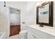 Bright bathroom with a vanity, a framed mirror and tiled shower at 121 W Oakland Ave, Oakland, FL 34760