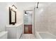Bright bathroom with a vanity, shower and tiled tub at 121 W Oakland Ave, Oakland, FL 34760