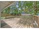 Large, wooden backyard deck surrounded by mature trees and lush landscaping at 121 W Oakland Ave, Oakland, FL 34760