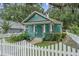 Charming home with a white picket fence and lush landscaping at 121 W Oakland Ave, Oakland, FL 34760