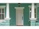 Inviting front entrance with decorative columns and a charming porch at 121 W Oakland Ave, Oakland, FL 34760