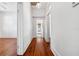 Hallway with hardwood floors, neutral walls, and bright natural light at 121 W Oakland Ave, Oakland, FL 34760