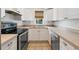 Kitchen featuring stainless steel appliances, white cabinets, and double sink at 121 W Oakland Ave, Oakland, FL 34760