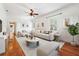 Bright living room with hardwood floors, neutral decor, and abundant natural light at 121 W Oakland Ave, Oakland, FL 34760