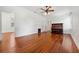 Spacious living room features pristine hard wood floors and a vintage piano at 121 W Oakland Ave, Oakland, FL 34760