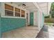 Outdoor covered patio with tiled flooring and tongue-in-groove ceiling at 121 W Oakland Ave, Oakland, FL 34760