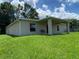 Backyard featuring a well-maintained lawn and a covered patio at 1227 Juniper Hammock St, Winter Garden, FL 34787