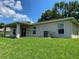 Backyard featuring a well-maintained lawn and a covered patio at 1227 Juniper Hammock St, Winter Garden, FL 34787