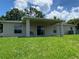 View of backyard with lush green grass and a covered patio at 1227 Juniper Hammock St, Winter Garden, FL 34787