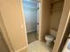 Compact half bathroom featuring neutral walls and a toilet at 1227 Juniper Hammock St, Winter Garden, FL 34787