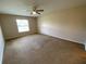 Large bedroom with natural light, ceiling fan, and neutral carpet at 1227 Juniper Hammock St, Winter Garden, FL 34787