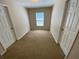 Small bedroom with carpet, window, and bi-fold doors to closet at 1227 Juniper Hammock St, Winter Garden, FL 34787