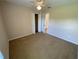 Bedroom with carpet, ceiling fan, closet, and view to hall at 1227 Juniper Hammock St, Winter Garden, FL 34787