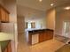 Bright open kitchen area featuring wood cabinetry with views to the living room at 1227 Juniper Hammock St, Winter Garden, FL 34787