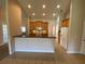 Open kitchen with light wood cabinets, bar, and white appliances at 1227 Juniper Hammock St, Winter Garden, FL 34787