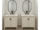 Bathroom featuring double vanity with modern mirrors, fixtures, and classic cabinets at 1309 Hillsborough Ln, Kissimmee, FL 34759