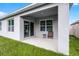 Back porch with seating and views of the landscaped backyard at 1351 Fox Squirrel Dr, Davenport, FL 33897