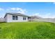 Spacious backyard with green grass and a white fence surrounding the property at 1351 Fox Squirrel Dr, Davenport, FL 33897
