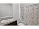 Bathroom with a shower-tub combo with Eiffel Tower curtain, modern vanity and sink at 1351 Fox Squirrel Dr, Davenport, FL 33897