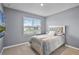 Bedroom featuring a comfortable bed, plush bedding, and a window providing natural light at 1351 Fox Squirrel Dr, Davenport, FL 33897
