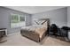 Serene bedroom with soft carpet, large window, and a modern bed frame at 1351 Fox Squirrel Dr, Davenport, FL 33897