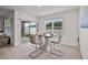 Cozy dining area with modern table and chairs, next to a sliding glass door at 1351 Fox Squirrel Dr, Davenport, FL 33897