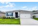 Charming single Gathering home featuring a well-manicured lawn and a classic two-car garage at 1351 Fox Squirrel Dr, Davenport, FL 33897